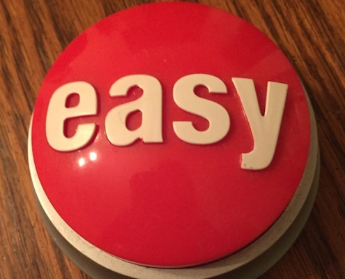 large play red push button with 'easy' written on it in white