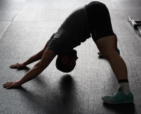 man bent over in downward dog yoga pose